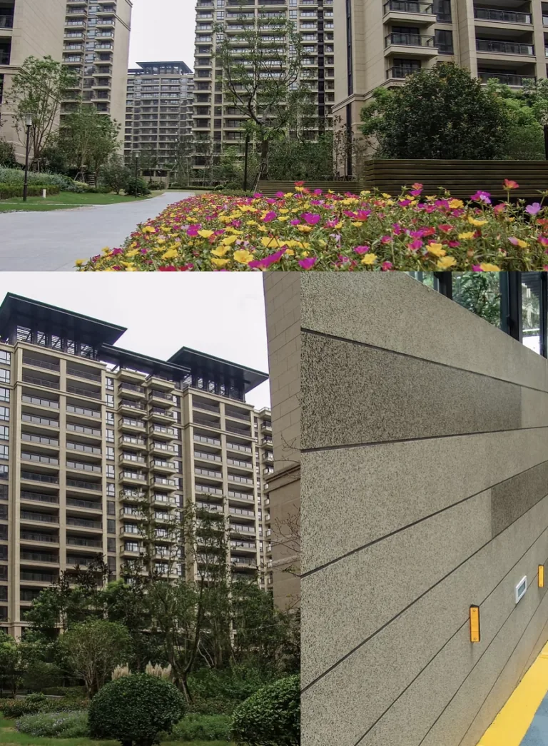 Modern apartment buildings stand behind a vibrant flower bed and manicured landscaping.