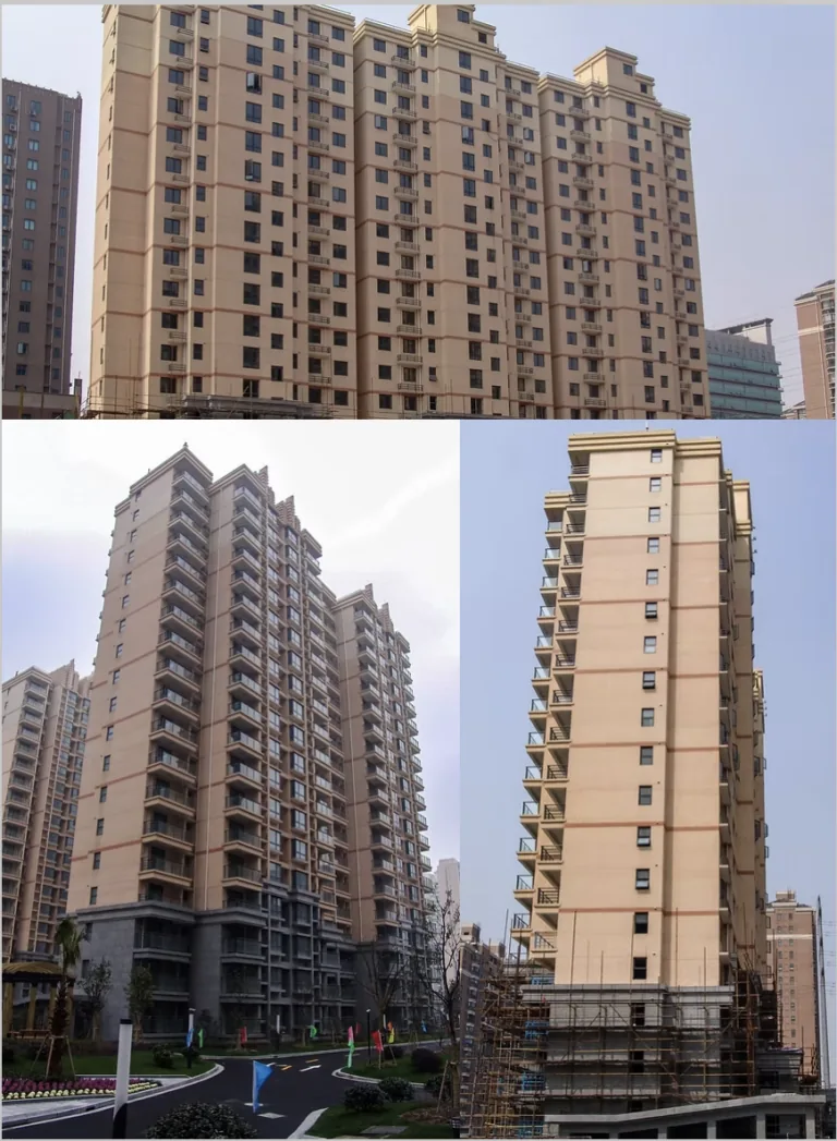Tall, beige apartment buildings with many balconies stand under a clear sky.